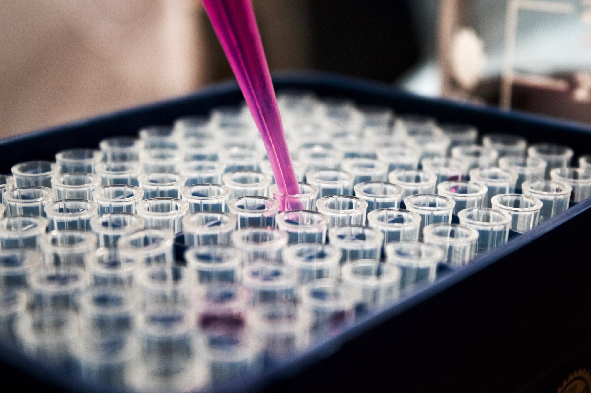 Pipette adding solution to test tubes. 
